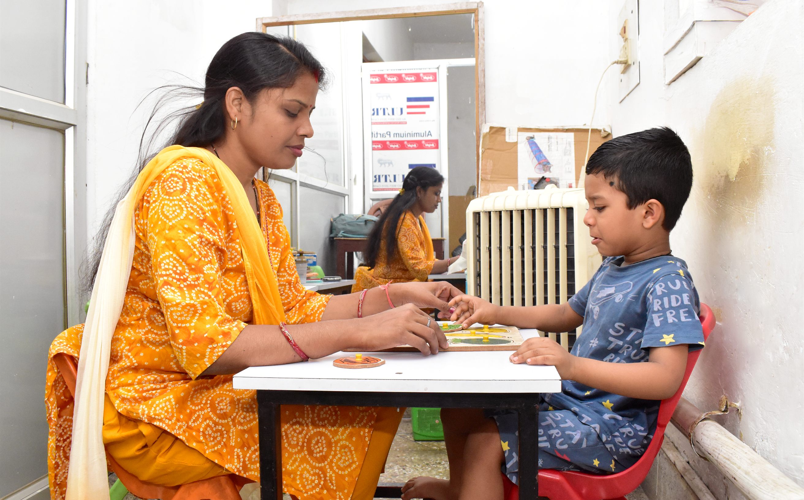 Parent observing a young child playing